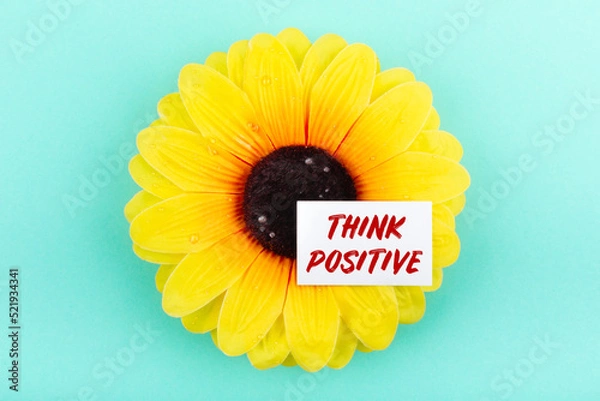 Obraz Text think positive on a white card on a large yellow flower. Мotivation concept.
