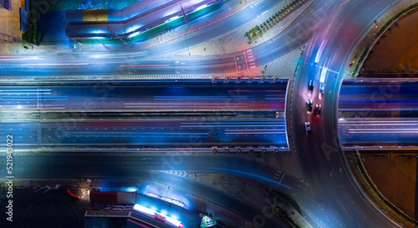 Fototapeta Expressway top view, Road traffic an important infrastructure,car traffic transportation above intersection road in city night, aerial view cityscape of advanced innovation, financial technology	

