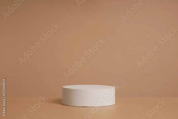 Obraz Abstract empty white podium with geometric shadows and pink flowers on blue background. Mock up stand for product presentation.Minimal concept. Advertising template