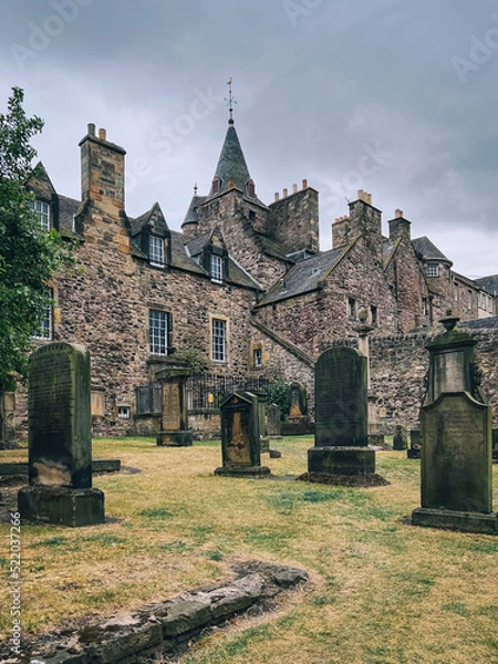 Obraz Edinburgh, Scotland, UK - July 2022: Gravestones on the graveyard behind Canongate Kirk on a cloudy afternoon