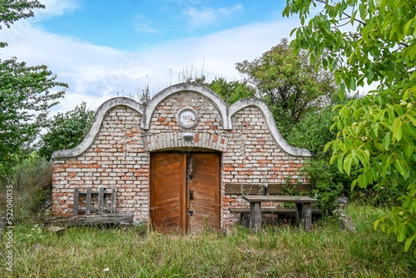 Fototapeta A beautiful old wine cellar on the edge of a field.