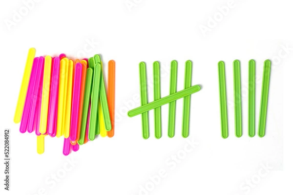 Obraz counting colorful sticks for the purposes of early education, development, learning to count and play. Banner with colored sticks on isolated white background