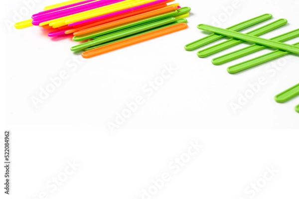 Obraz counting colorful sticks for the purposes of early education, development, learning to count and play. Banner with colored sticks on isolated white background