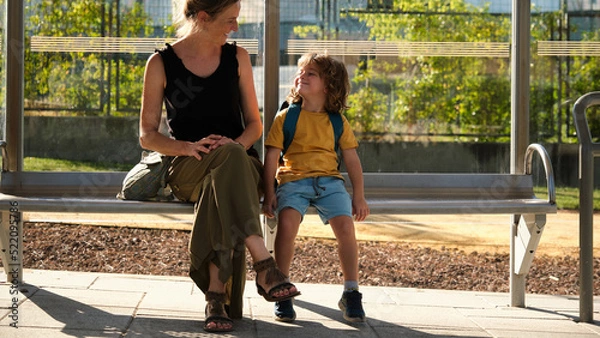 Obraz Mother and small toddler are waiting for the bus at the bus stop