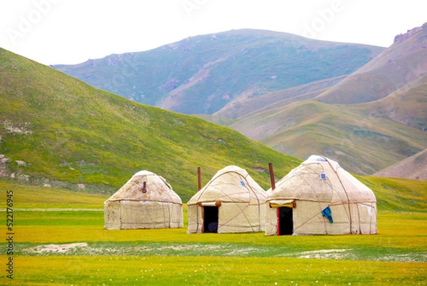 Fototapeta Yurt. National old house of the peoples of Kyrgyzstan and Asian countries. national housing. Yurts on the background of green meadows and highlands. Yurt camp for tourists.
