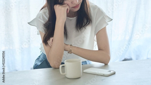 Fototapeta 肘をついて考え込む女性