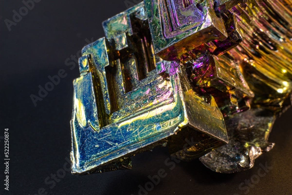 Fototapeta Bismuth bi close up on black surface.Interesting colour and shape crystal. Metal crystal