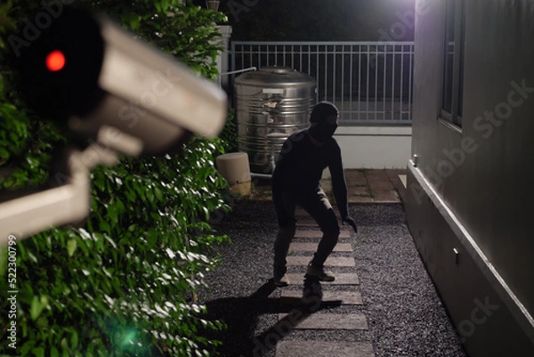 Fototapeta CCTV Surveillance camera capturing thief during breaking into house