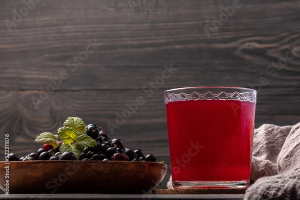 Obraz blackcurrant compote in a glass  and berries