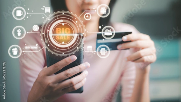 Fototapeta Young woman using credit card online shopping via smartphone,consumer payment concept with internet technology,e-commerce payment,Consumer society,Shopping service on The online web.