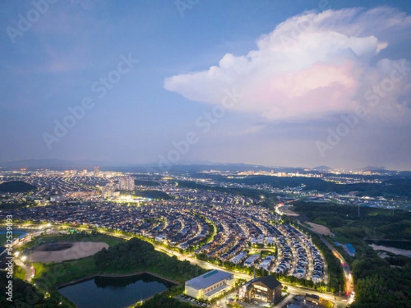 Fototapeta Aerial view of baseball field and lights from suburban community at night