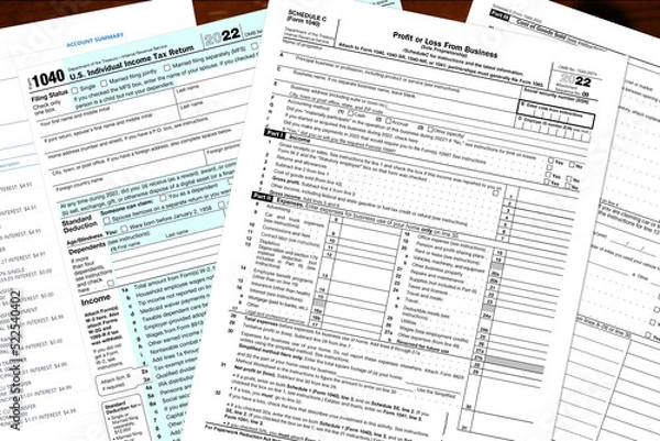Obraz 2022 IRS tax forms on a desktop.