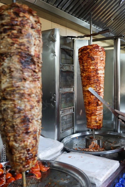 Fototapeta Stacked Chicken and Beef roasting  preparation of traditional Turkish  doner and shawarma in Dubai United Arab  Emirates 