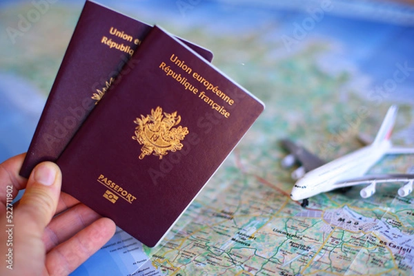 Fototapeta French passport with blurred map in background - travel concept