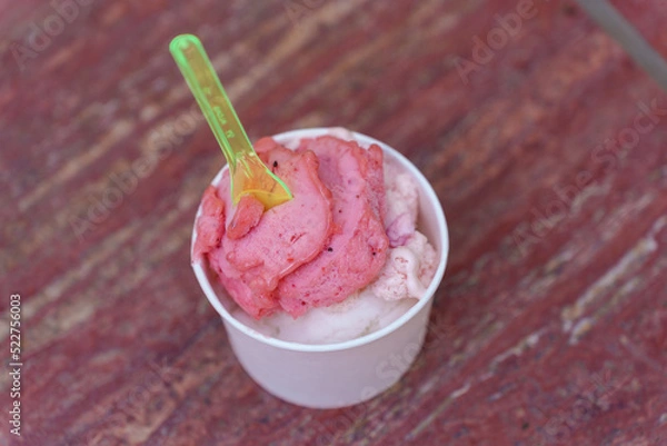 Obraz Popsicles in paper cup on red stone texture background.