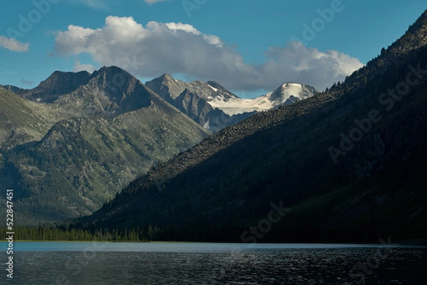 Fototapeta The smooth surface of a glacial lake at the foot of the Altai Mountains in the Katunsky Reserve