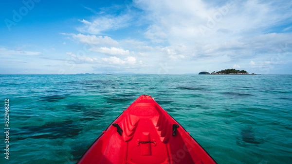 Fototapeta First person view of adventure sea kayak heading to Koh Kra small island. Floating on crystal clear turquoise water and coral reef against summer blue sky. Koh Lipe Island, Satun, Thailand.