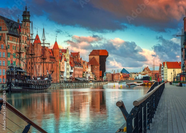 Fototapeta Old town in Gdansk with historical port crane over Motlawa river at sunrise, Poland.