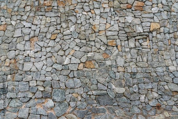 Obraz The wall was built of roughly worked multi-colored stone.