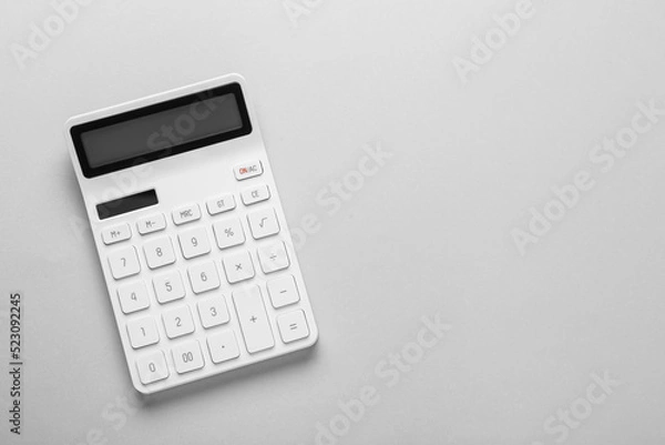 Obraz White calculator on light background, top view. Space for text
