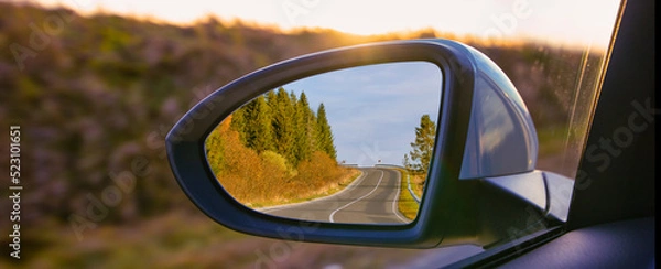 Obraz The view of the mountains in the car's rearview mirror.