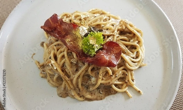 Fototapeta Truffle Cheese Cream Pasta Topped with Bacon.