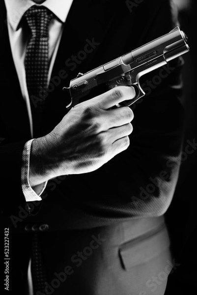 Obraz Elegant man holding gun