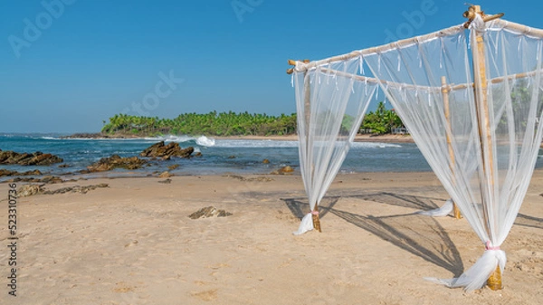 Fototapeta Light bamboo canopy on a deserted beach