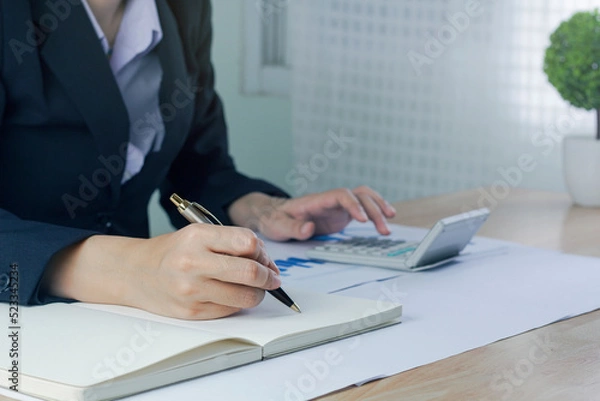 Fototapeta Business woman Write note and  analyzing data from market report.Business Financial Concept