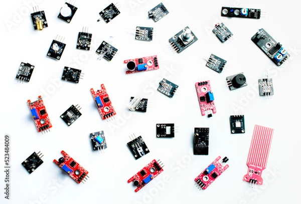 Fototapeta Arduino DIY modules on a white background. Selective focus. Red and black PCB. Blue potentiometers. Technological concept. Top view. Background picture. 
