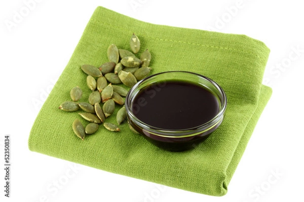 Fototapeta Pumpkin Seed Oil and some Roasted Pumpkin Seeds