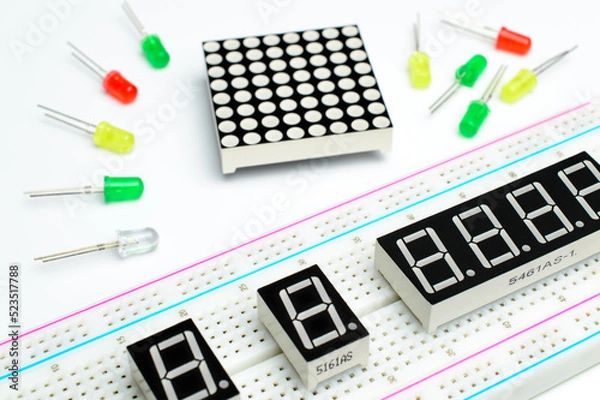 Fototapeta Breadboard close-up, seven segment indicators and color led lamp. LED matrix and colorful diodes. Concept of a DIY arduino project. Background picture.