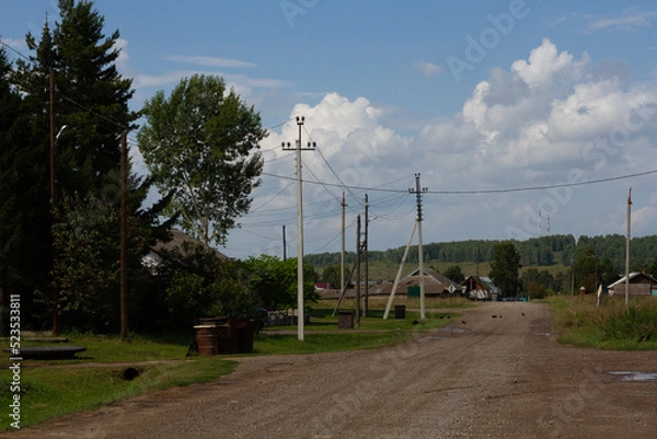 Fototapeta View of the street and power poles on a sunny day