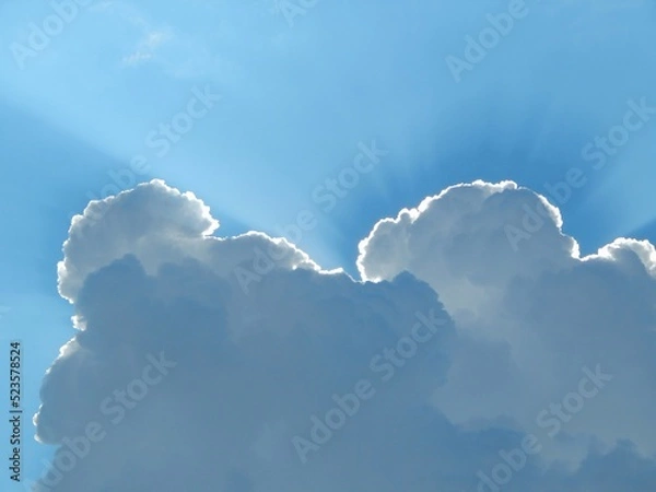 Obraz Beautiful sky background. Clouds in the blue sky illuminated by the sun.
