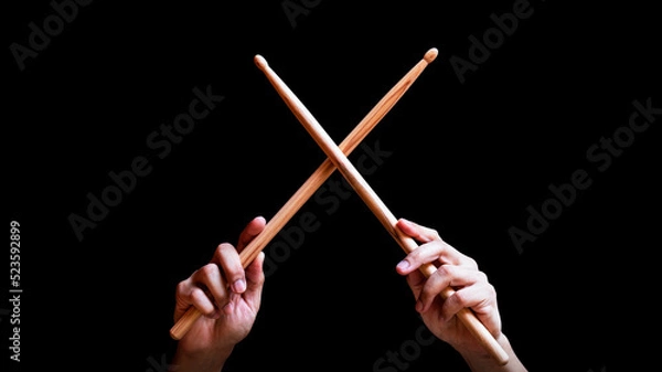 Obraz male drummer hands holding drumsticks in x shape. isolated on black