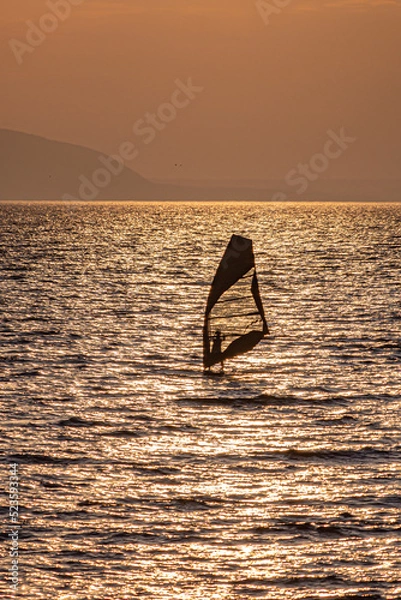 Obraz Lonely silhouette of a windsurfer on the water surface