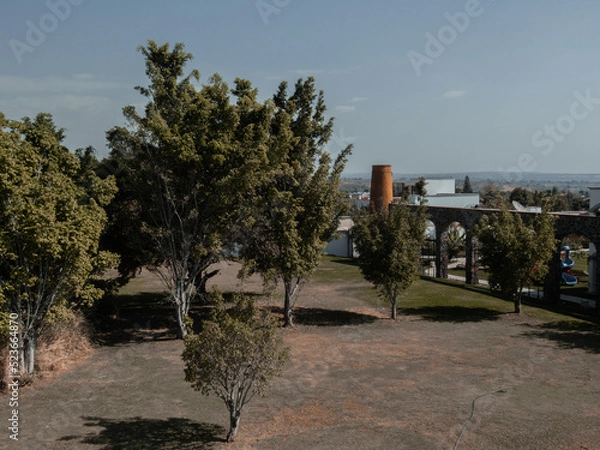 Obraz Park with brick mill and large trees
