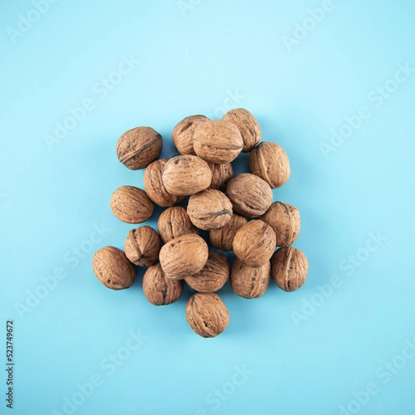 Obraz Top view walnuts on blue background