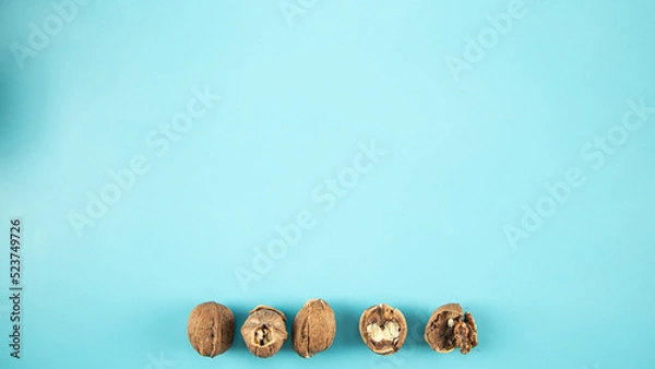 Obraz Top view walnuts on blue background
