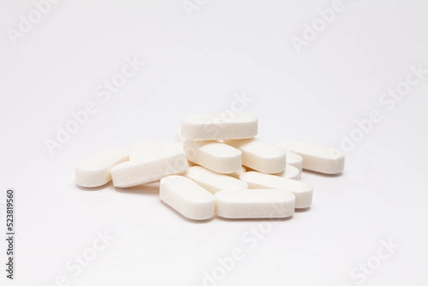 Obraz Pills drugs tablets vitamins macro image on white background