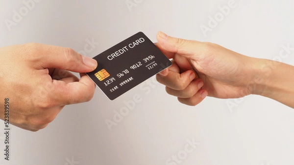 Fototapeta Two hands is send and receive black credit card on white background