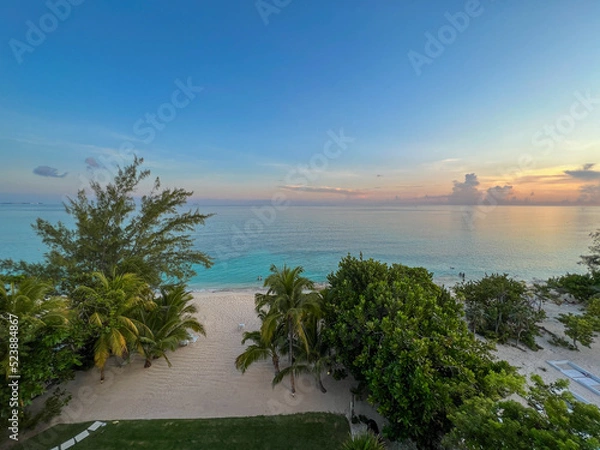 Obraz An aerial view of Cemetery Beach on Seven Mile Beach in Grand Cayman Island with a beautiful sunset.