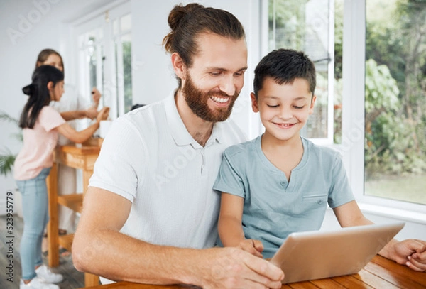 Fototapeta Learning with tablet, watching educational videos and searching the internet with father and son relaxing together at home. Smiling, curious and happy boy browsing the web and having fun with parent