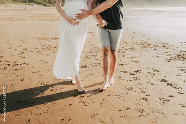 Obraz wedding couple sitting embraced on the beach