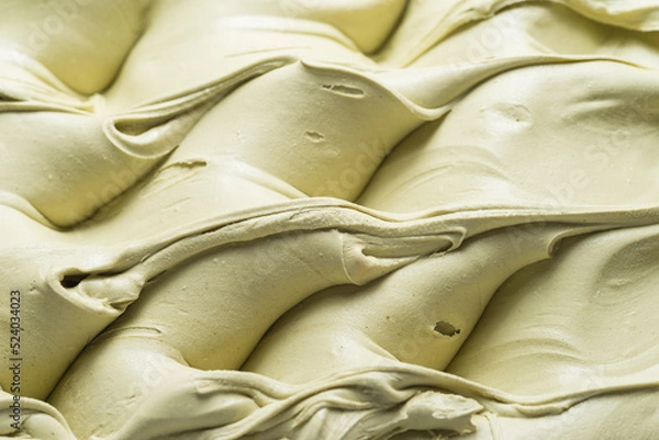 Fototapeta Frozen Pistachio flavour gelato - full frame detail. Close up of a creamy pastel green surface texture of Ice cream.