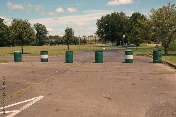 Fototapeta Road Block with Six Green and White Barrels in Daylight