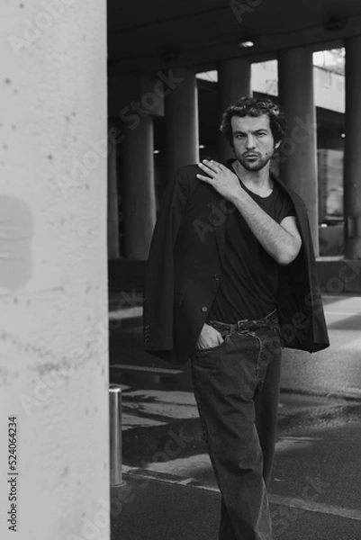 Fototapeta A stylish portrait of a charismatic man in the city 