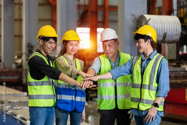 Fototapeta Success teamwork concept. engineer factory group joining hands, engineer team and partnership successful service support workshop.