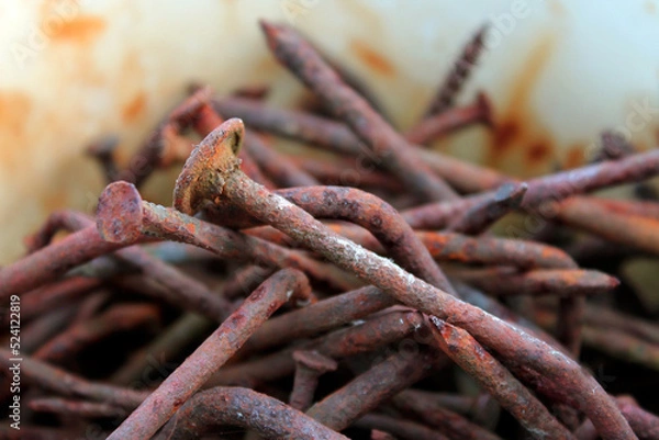 Fototapeta rusty nails, a handful of rusty nails, rust, metal corrosion, background old nails closeup with blurred background