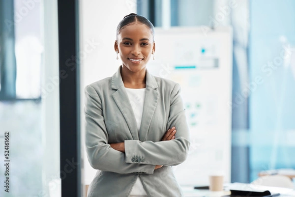 Fototapeta Proud, formal corporate businesswoman with arms crossed showing professional leadership, in marketing strategy presentation. Smiling employee standing in company boardroom for business meeting